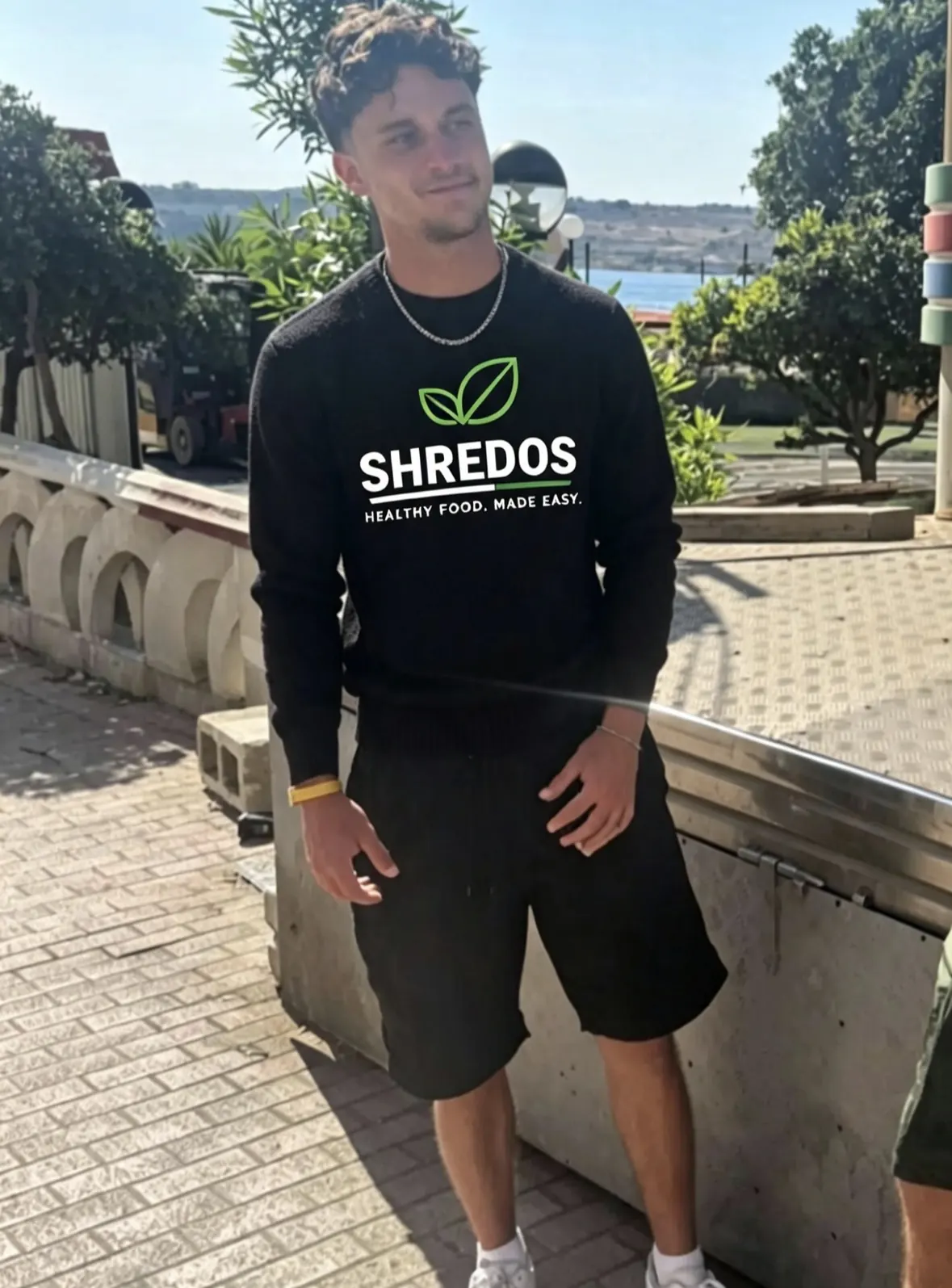 Shredos founder wearing branded sweatshirt outdoors